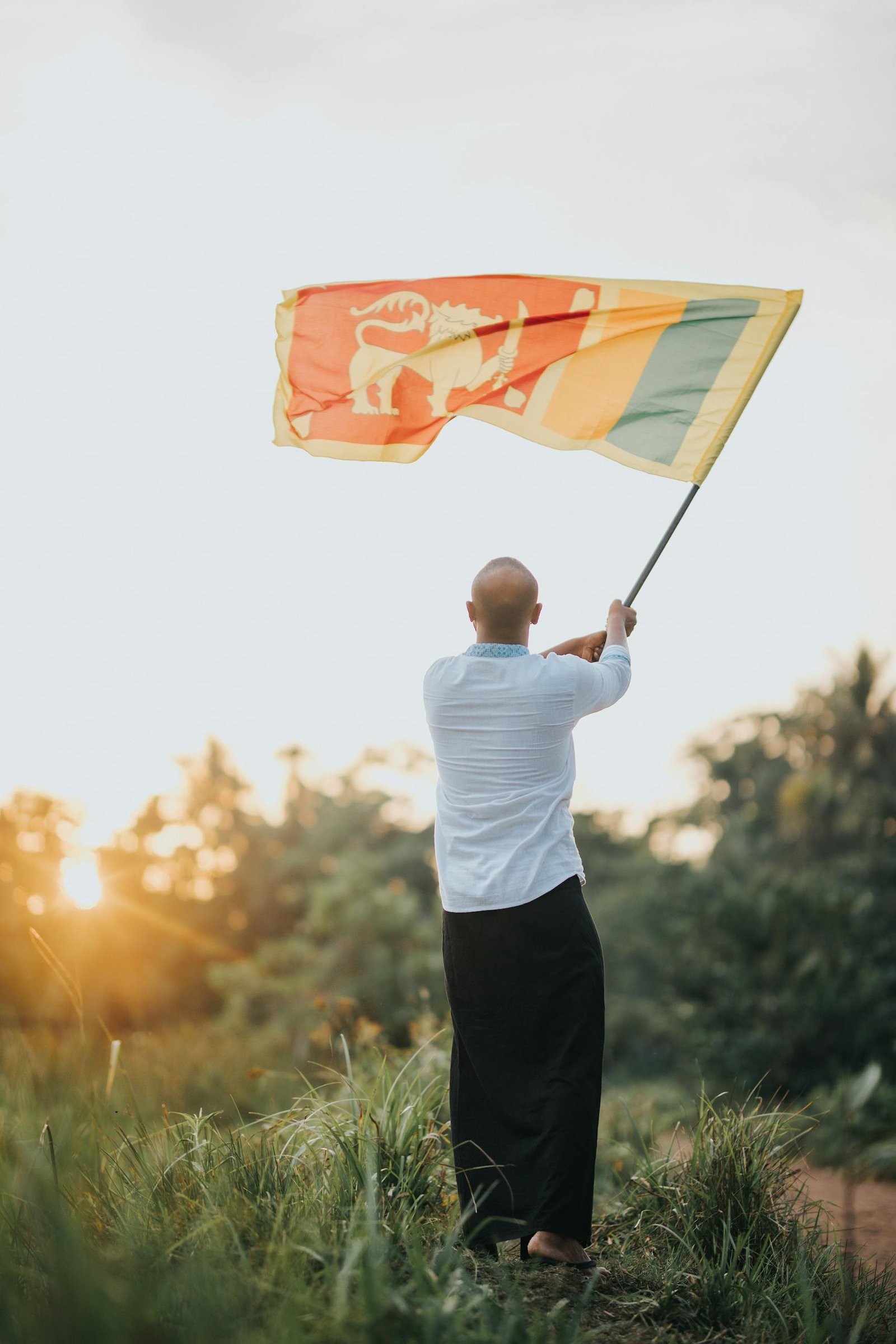 A Man Waving the Flag of Sri Lanka