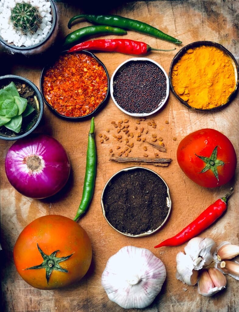 spices and vegetables on a wooden tray