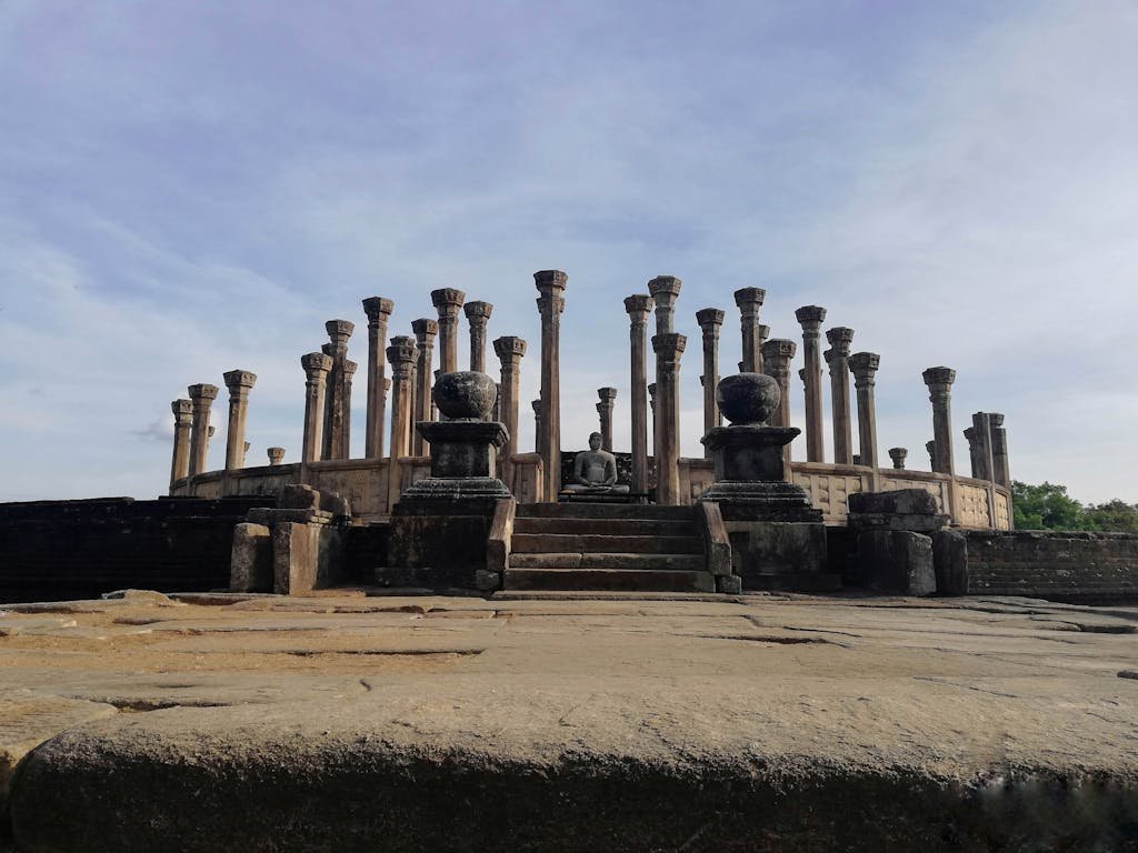 Pillars of Medirigiriya Vatadage Under a Blue Sky