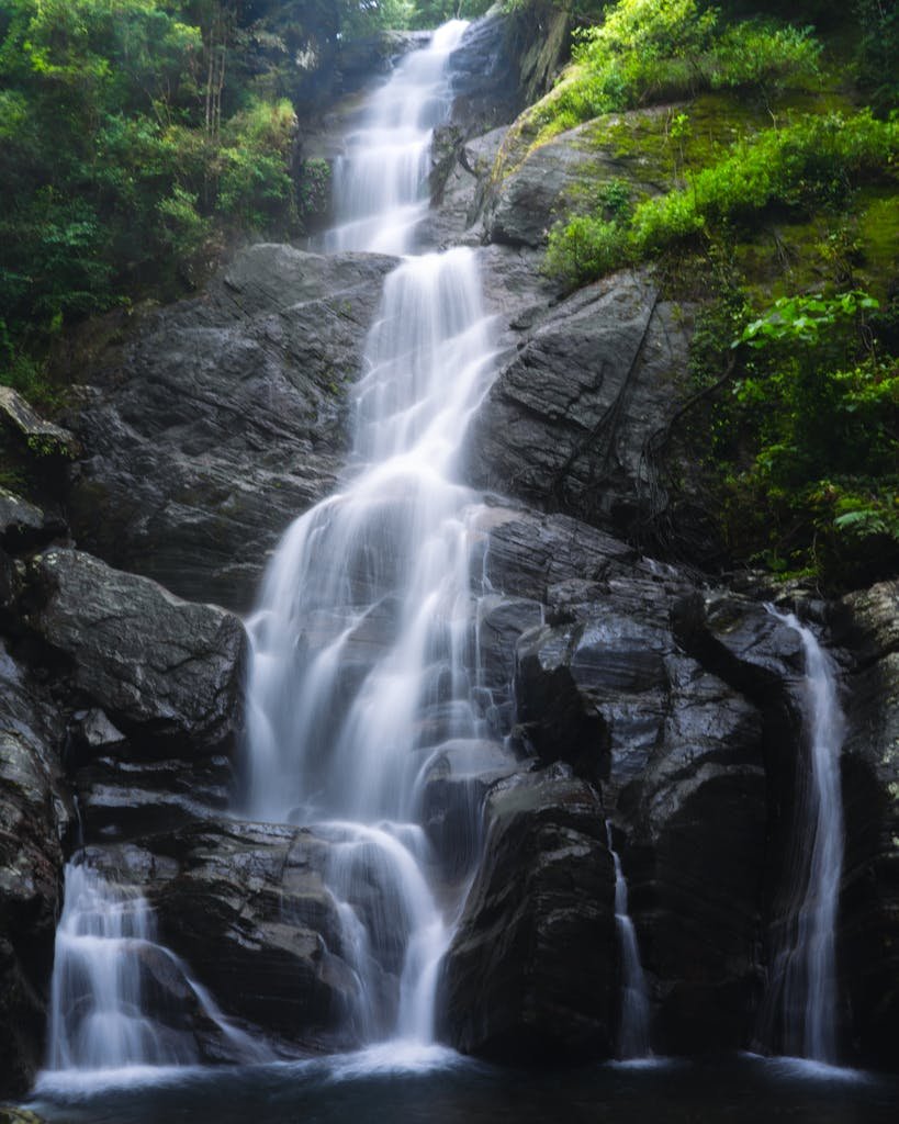 Waterfall Cascading Over Rocks in the Wilderness