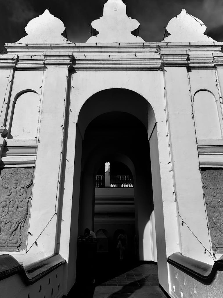kandy day tour .explore the ornate architectural entrance of Kandy's iconic landmark in black and white.